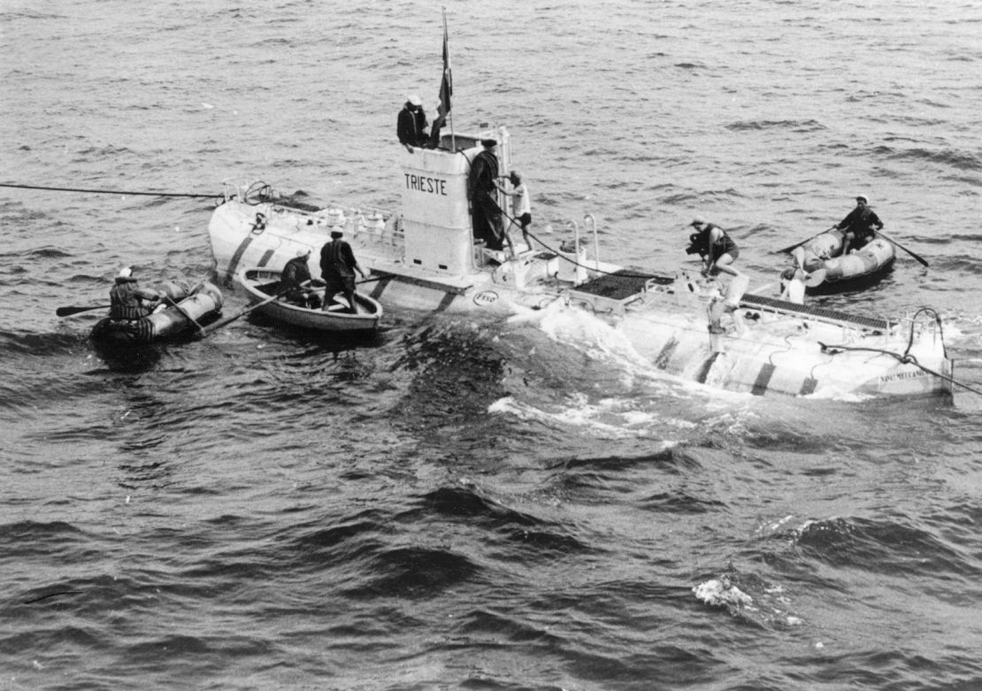 3rd October 1953: Professor Auguste Piccard (1884 - 1962 ), is seen wearing a life-jacket as he emerges from the conning tower of the bathyscaphe 'Trieste' after making a world record dive of 10,335 feet. The dive was made 50 miles from Pinza Island off the west coast of Italy. (Photo by Keystone/Getty Images)