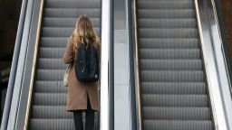An office worker rides an escalator at London Bridge railway station in London, UK, on Tuesday, March 21, 2023. 