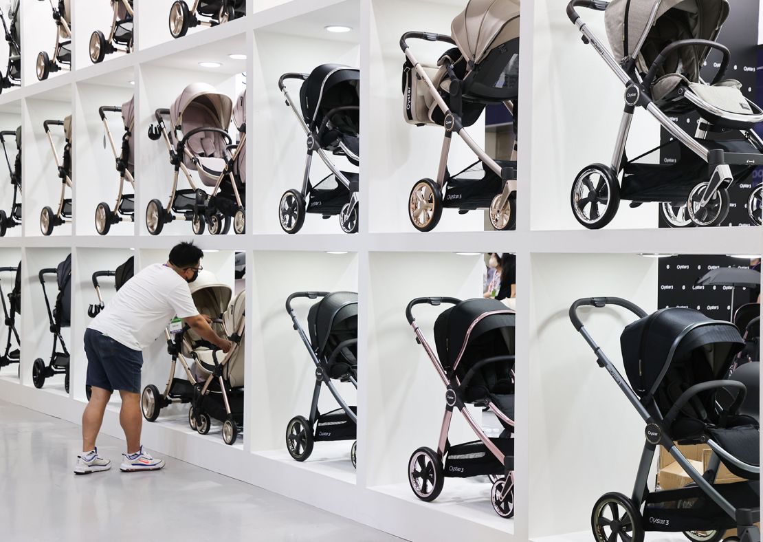A man looks at strollers at a baby fair in Seoul, South Korea, in September 2022. South Korea's fertility rate is the lowest in the world.