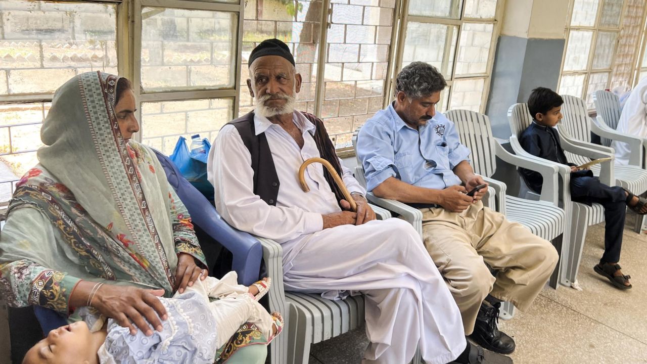 Family members sit for DNA sampling at a hospital in Khuiratta in Pakistan-administered Kashmir on June 20.