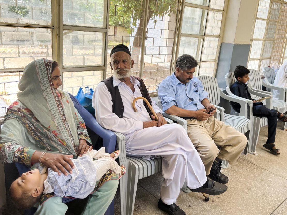 Family members sit for DNA sampling at a hospital in Khuiratta in Pakistan-administered Kashmir on June 20.