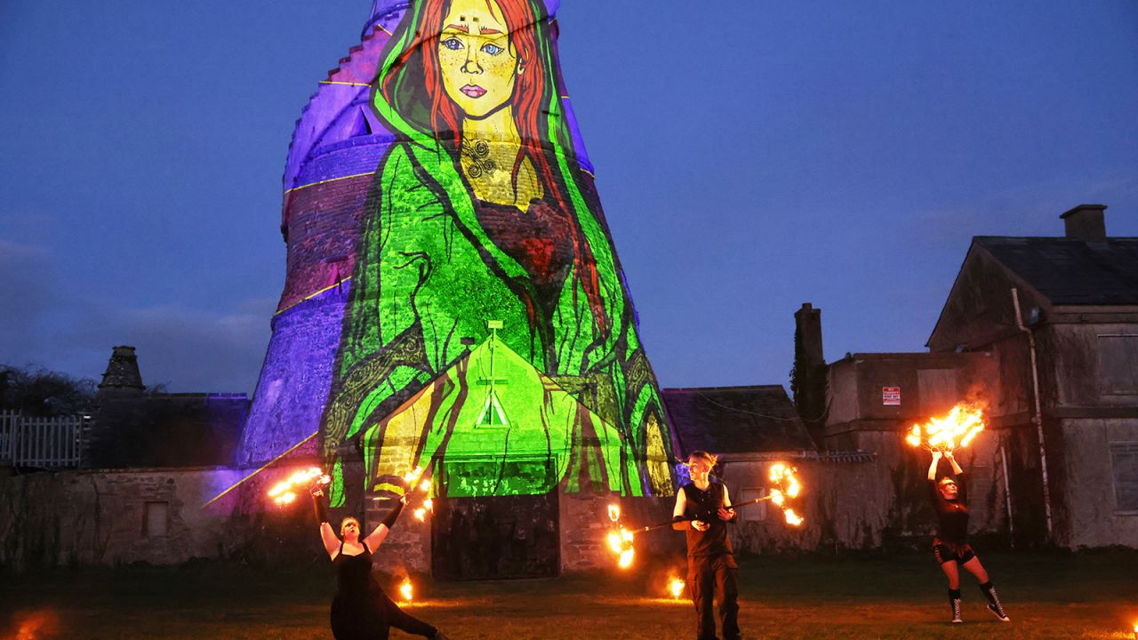Dancers perform in front of an image of St. Brigid projected onto The Wonderful Barn in Leixlip, Kildare, Ireland, Tuesday, Jan. 31, 2023 during the Herstory Festival of Light. St. Brigid of Kildare, a younger contemporary of St. Patrick, is quietly and steadily gaining a following, in Ireland and abroad. Devotees see Brigid, and the ancient Irish goddess whose name and attributes she shares, as emblematic of feminine spirituality and empowerment. (AP Photo/Peter Morrison)