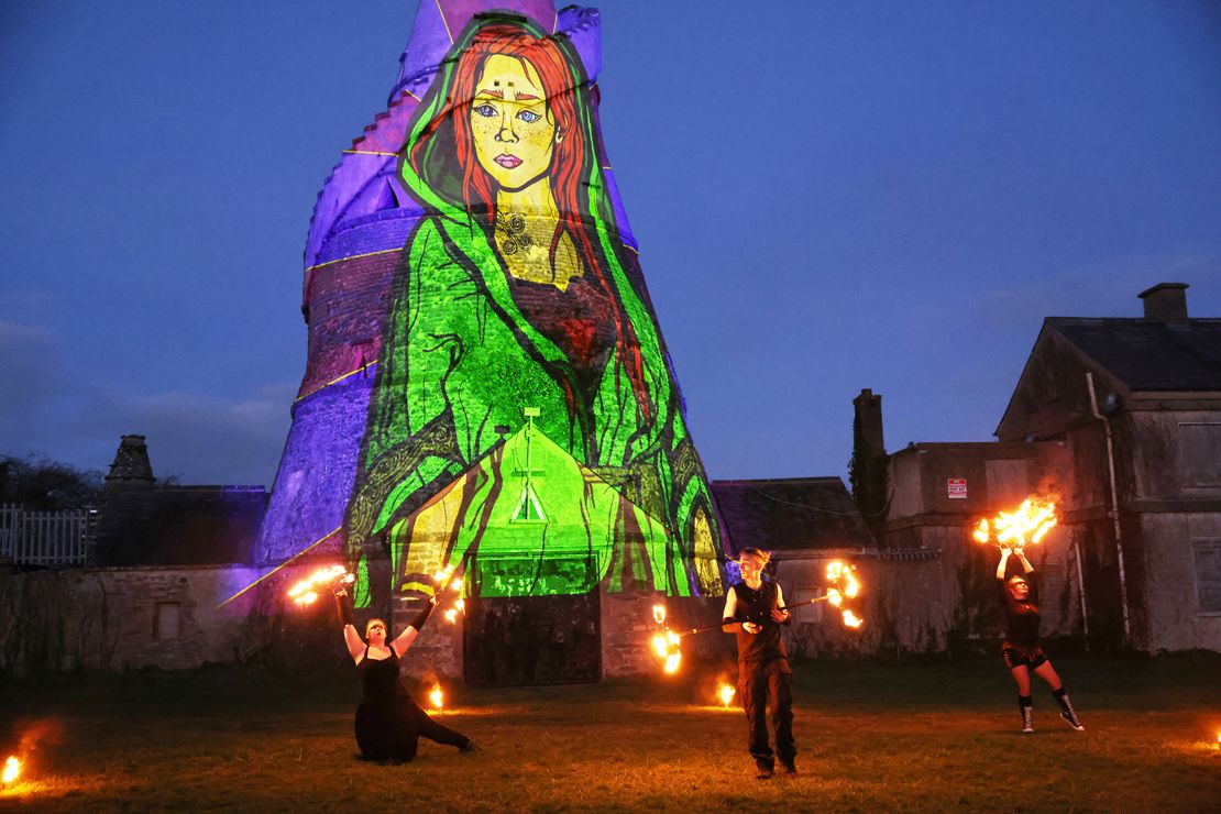 Dancers perform in front of an image of St. Brigid projected onto The Wonderful Barn in Leixlip, Kildare, Ireland, Tuesday, Jan. 31, 2023 during the Herstory Festival of Light. St. Brigid of Kildare, a younger contemporary of St. Patrick, is quietly and steadily gaining a following, in Ireland and abroad. Devotees see Brigid, and the ancient Irish goddess whose name and attributes she shares, as emblematic of feminine spirituality and empowerment. (AP Photo/Peter Morrison)