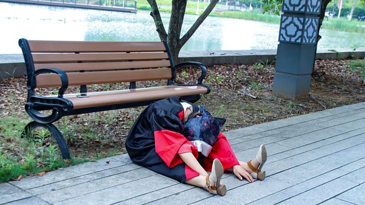 Li Nian is among many Chinese students taking unconventional graduation photos, which often show them slumped or on the ground.