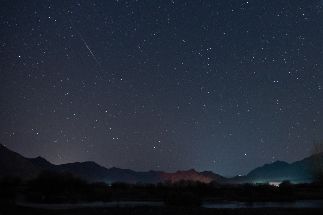 LHASA, CHINA -  DECEMBER 14: A meteor of Geminid meteor shower streaks across the night sky over the Lhasa River on December 14, 2022 in Lhasa, Tibet Autonomous Region of China. (Photo by Jiang Feibo/China News Service/VCG via Getty Images)