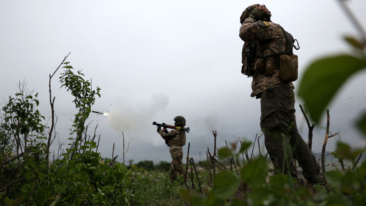 Ukrainian soldiers of the 28th Separate Mechanized Brigade fire a grenade launcher at the front line near the town of Bakhmut, Donetsk region, on June 17, 2023.