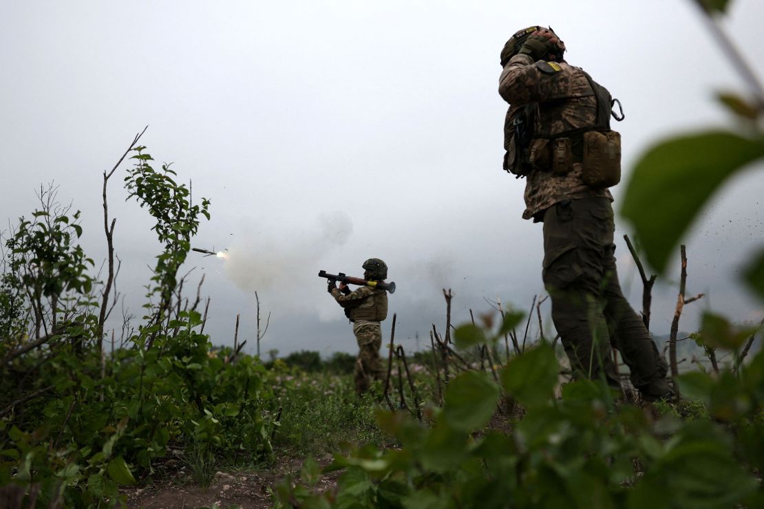 Ukrainian soldiers of the 28th Separate Mechanized Brigade fire a grenade launcher at the front line near the town of Bakhmut, Donetsk region, on June 17, 2023.