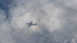 The shadow of a Royal Canadian Air Force CP-140 Aurora maritime surveillance aircraft of 14 Wing forms on cloud cover as it flies a search pattern for the missing OceanGate submersible, which had been carrying five people to explore the wreck of the sunken SS Titanic, in the Atlantic Ocean off Newfoundland, Canada, on June 20, 2023 in a still image from video.