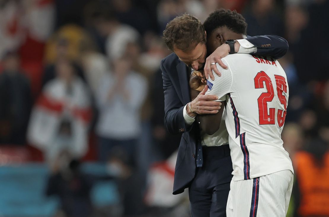 England manager Gareth Southgate consoles his player Bukayo Saka after his decisive miss in the penalty shootout gave Italy victory during the Italy v England Euro 2020 final at Wembley Stadium on July 11th 2021 in London (Photo by Tom Jenkins)