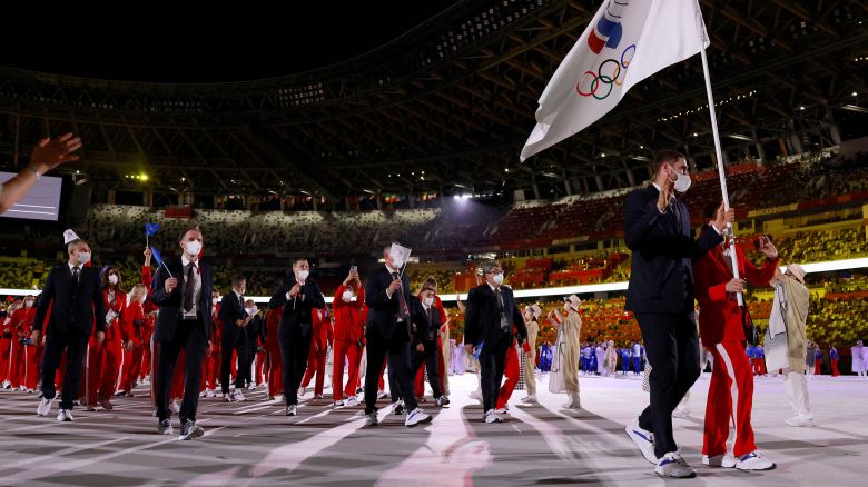 Russia's (ROC) flag bearers Sofya Velikaya  (R) and   Maxim Mikhaylov  lead their delegation as they parade   during the opening ceremony of the Tokyo 2020 Olympic Games, at the Olympic Stadium, in Tokyo, on July 23, 2021.