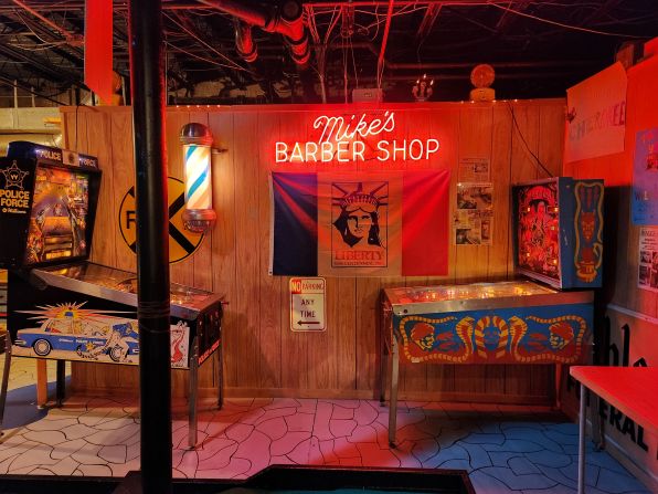 Twenty feet below ground with no windows, a neon sign collected from one of the village's old barber shops helps to illuminate the basement The sign is one piece of an array of local memorabilia that decorate the room.