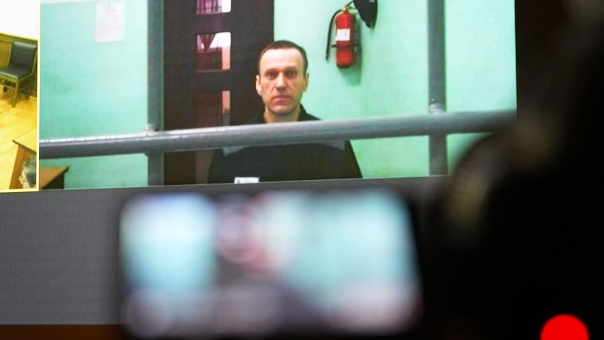 Russian opposition leader Alexei Navalny is seen on a TV screen as he appears in a video link provided by the Russian Federal Penitentiary Servic