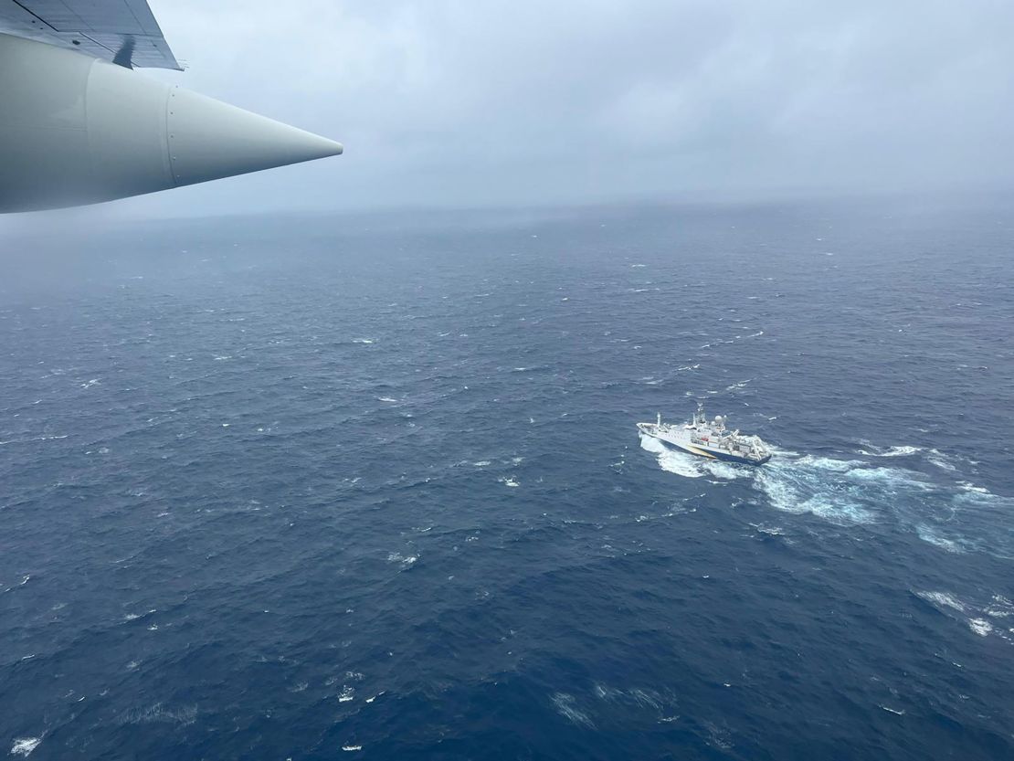 A Coast Guard Air Station Elizabeth City, North Carolina HC-130 Hercules airplane flies over the French research vessel, L'Atalante approximately 900 miles East of Cape Cod during the search for the 21-foot submersible, Titan, June 21, 2023. The unified command is searching for five people after the Canadian research vessel Polar Prince lost contact with their submersible during a dive June 18, 2023.