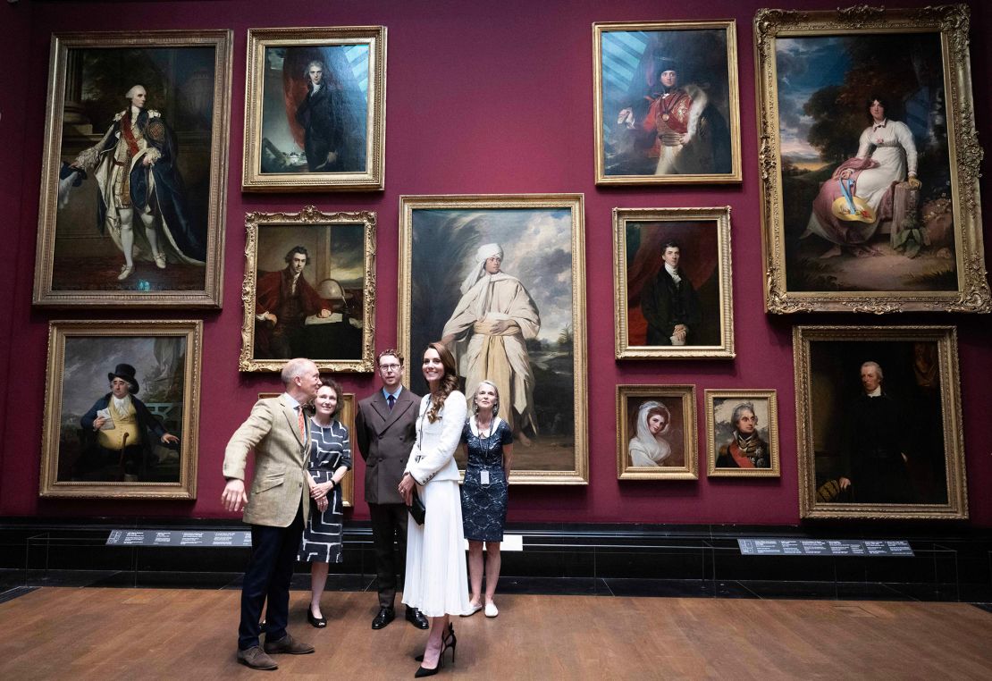 Britain's Catherine, Princess of Wales (4L) reacts as she is shown a gallering including artwork by Joshua Reynolds, including his painting entitled 'Portrait of Mai (Omai)' (C), as she attends the reopening of National Portrait Gallery, in London on June 20, 2023, following an extensive, three-year refurbishment programme. The transformation of the National Portrait Gallery marks the biggest redevelopment project that the building has seen since 1896. The refurbishment programme has seen a comprehensive redisplay of the Collection in beautifully refurbished galleries, including more than 50 new acquisitions, and the restoration of the Grade I listed building. The Gallery will reopen to members of the public from June 22, 2023. (Photo by Paul Grover / POOL / AFP) / RESTRICTED TO EDITORIAL USE - MANDATORY MENTION OF THE ARTIST UPON PUBLICATION - TO ILLUSTRATE THE EVENT AS SPECIFIED IN THE CAPTION (Photo by PAUL GROVER/POOL/AFP via Getty Images)