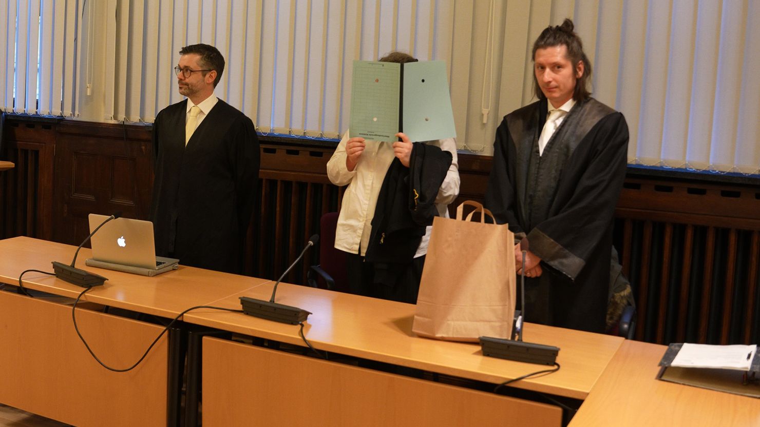 The defendant pictured standing between her lawyers at the start of her trial in January.