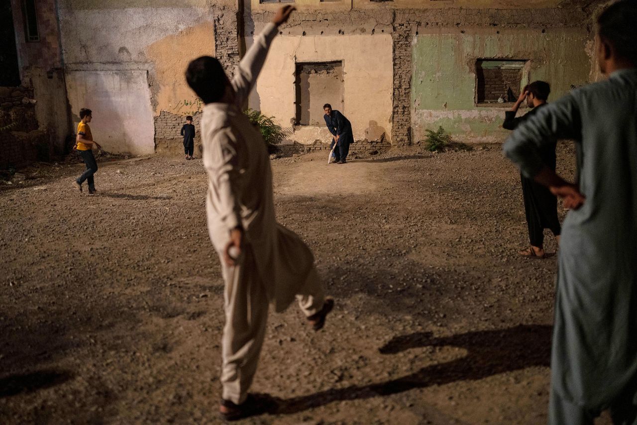 Men play cricket at night in Kabul, Afghanistan, on Thursday, June 22.