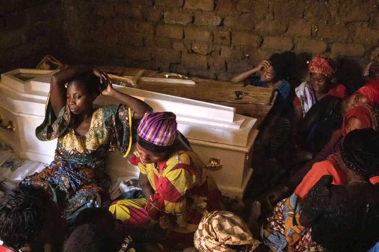 Relatives of Musa Kirelhuhandi, the gatekeeper at the Lhubirira Secondary School in Mpondwe, Uganda, attend his funeral in Bwera on Sunday, June 18. Kirelhuhandi and his 17-year-old son, Elton Masereka, were among dozens who were killed when members of a rebel group <a href="https://www.cnn.com/2023/06/21/africa/students-rescued-uganda-school-attack-intl/index.html" target="_blank">attacked the school</a>, hacking some of their victims to death with machetes and setting fire to the dormitories.