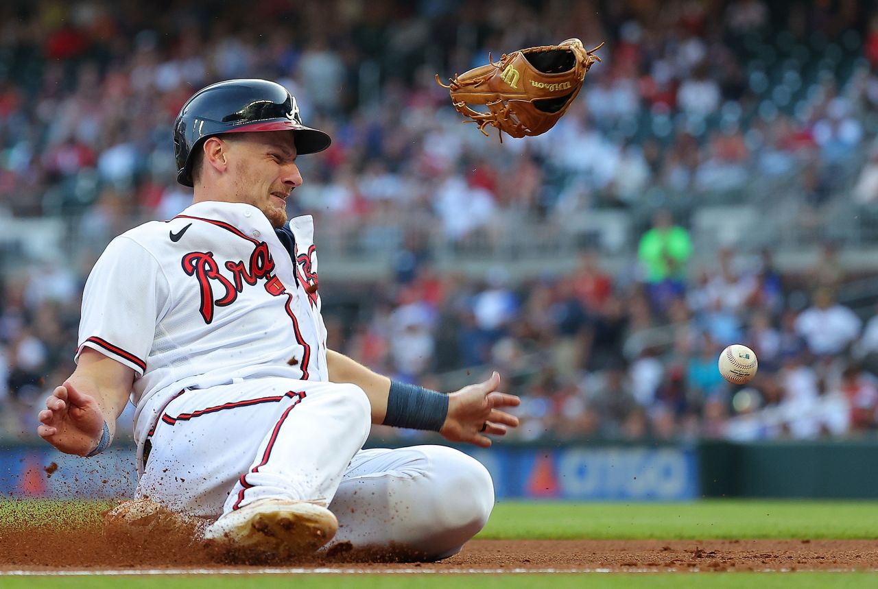 Atlanta Braves' Sean Murphy slides safely into third base after colliding with Colorado's Ryan McMahon, whose glove was knocked off during a Major League Baseball game in Atlanta on Thursday, June 15.