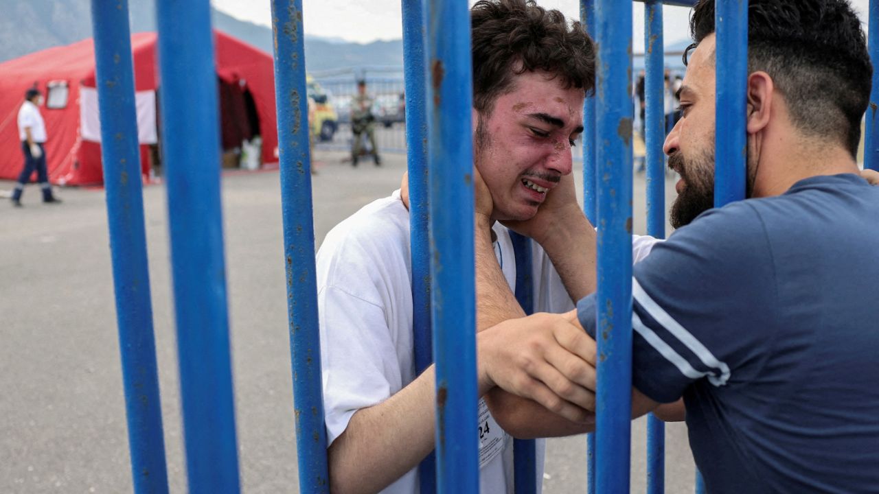 Syrian survivor Mohammad, 18, who was rescued at open sea, as he reunites with his brother Fadi, who came to meet him from the Netherlands, in Kalamata on June 16.