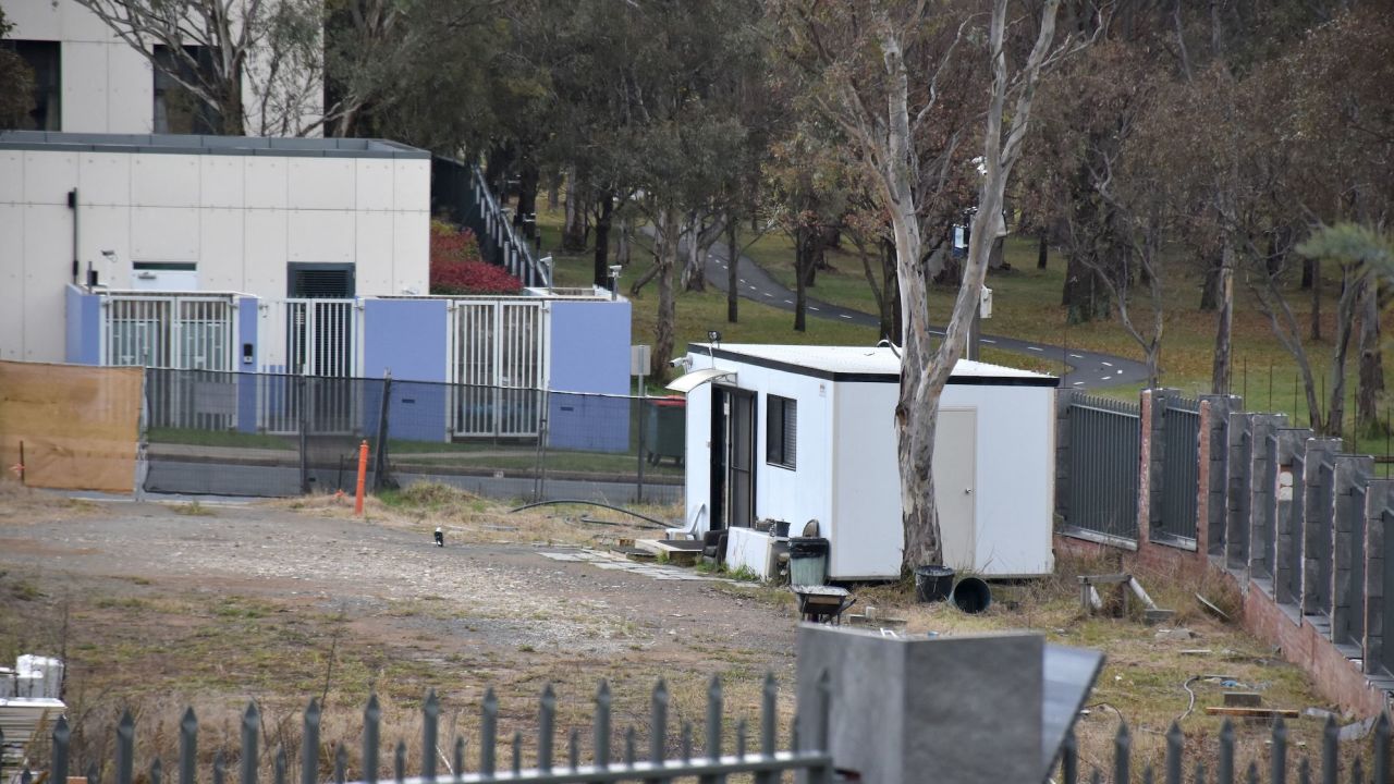 A portable security shed surrounded by weeds and discarded building materials on vacant land, which is a proposed new Russian embassy site, in Canberra on June 23.