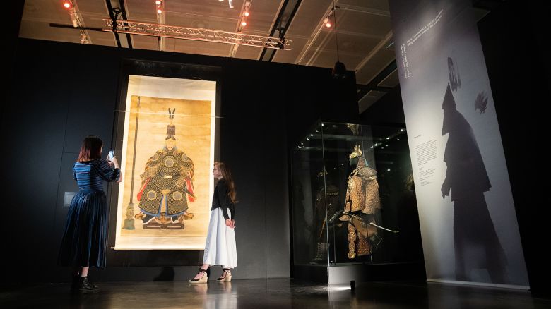 British Museum workers look at a work featured in its "China's hidden century" exhibition, which opened in London on May 18. 