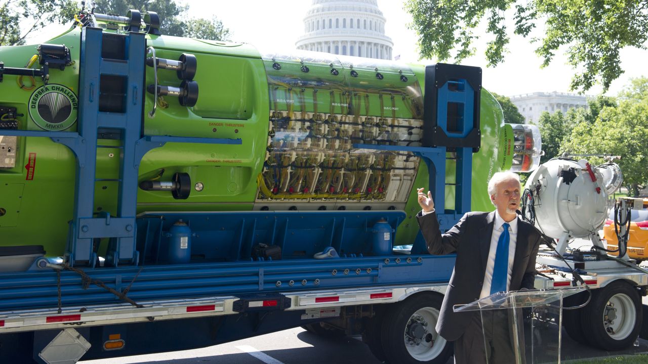 James Cameron speaks in front of the one-person submarine he helped develop, "Deepsea Challenger," in 2013.