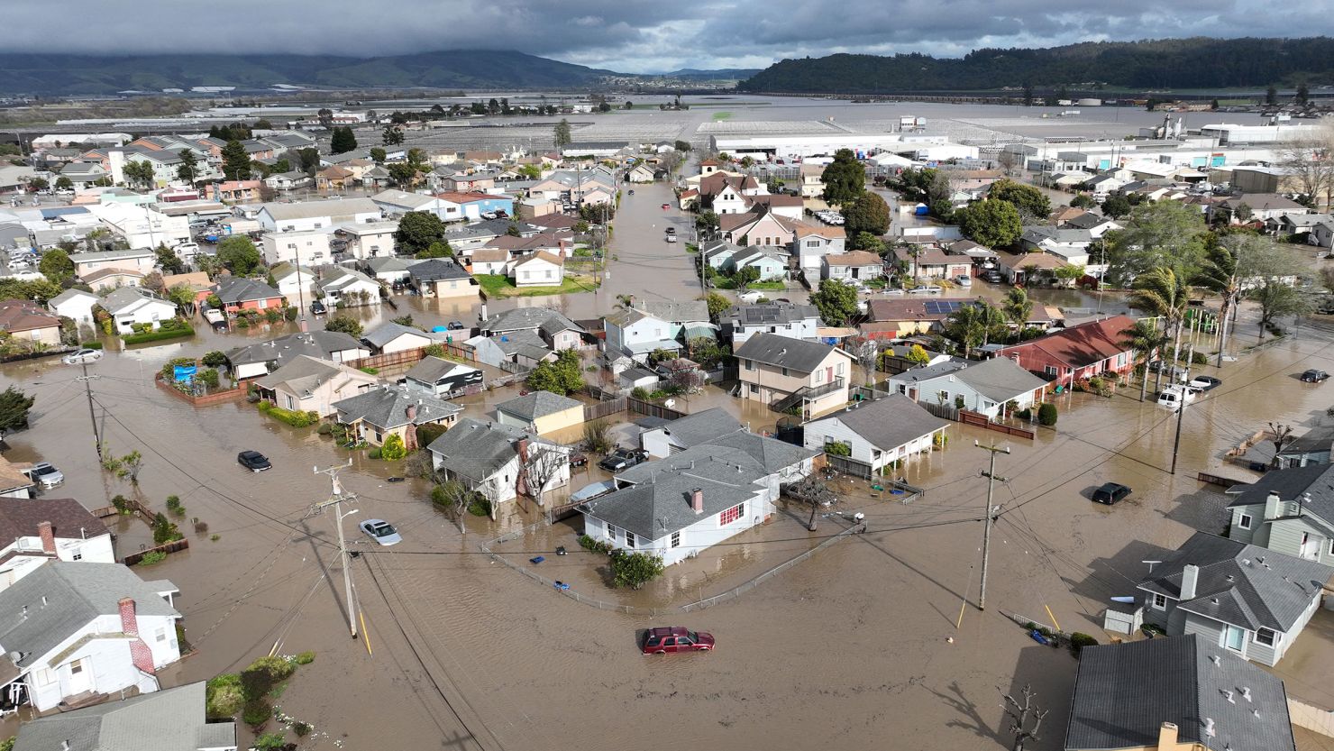 Vehicles and homes engulfed by floodwaters in Pajaro, California, on Saturday, March 11, 2023, after an atmospheric river dumped torrential rain on the region.