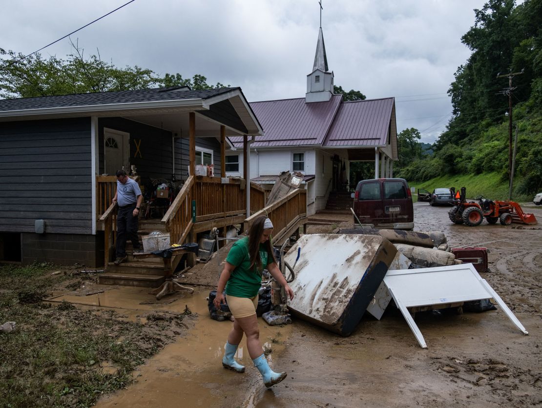A local fire chief and his daughter drop off goods for a community member in Jackson, Kentucky, on July 31, 2022, after deadly flooding.