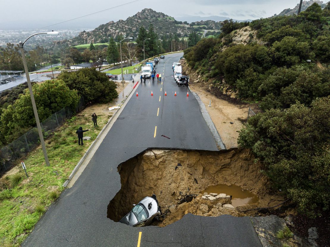 A large sinkhole opened up on a road in the Chatsworth area of Los Angeles in January, swallowing two vehicles, after torrential rain inundated the area.