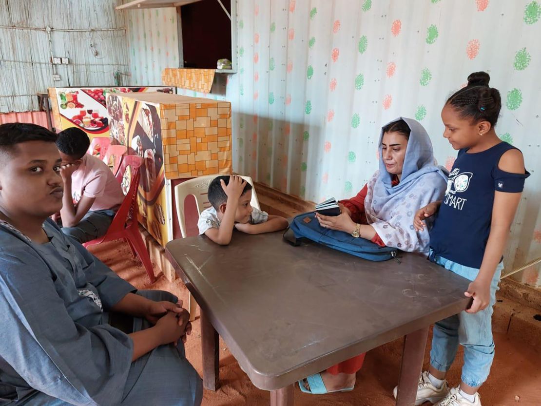 Sabah Ahmed (center right) sits in a cafe with her sons Mohamed, Zeyazen and Kareem and daughter, Renad, while they wait to be interviewed at the US embassy in Khartoum on March 9, 2023.