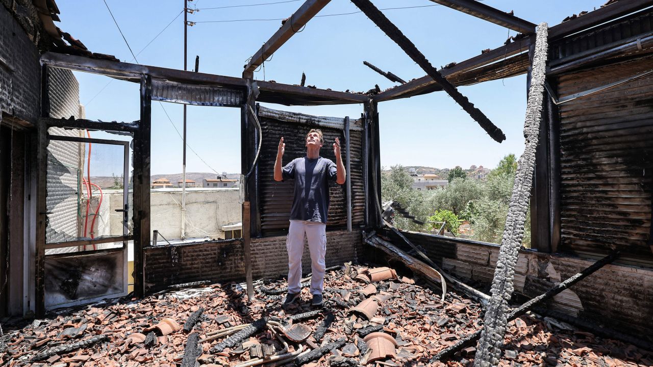 Sven Kuhn von Burgsdorff, head of the European Union's mission to the West Bank and Gaza Strip, reacts as he stands inside a destroyed building during a visit to the village of Turmusayya near the occupied West Bank city of Ramallah on June 23, 2023.