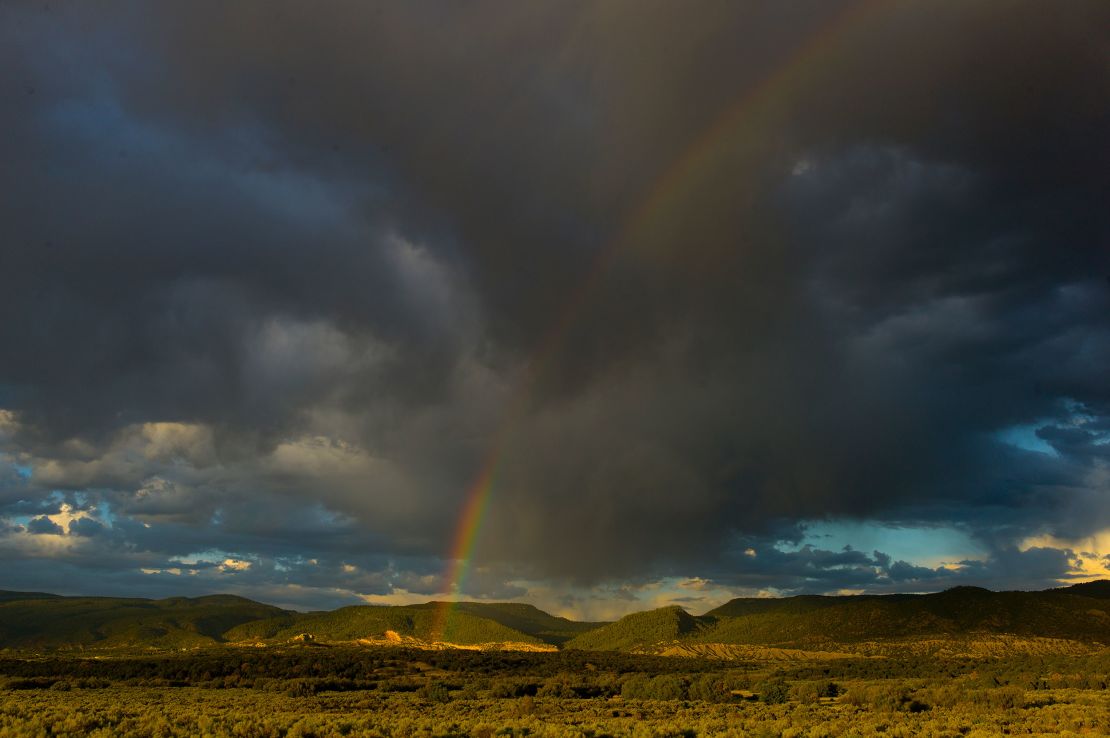 A rainbow appears over desert land near Cuba, New Mexico. The largely rural state has the third-highest rate of gun mortality in the United States.