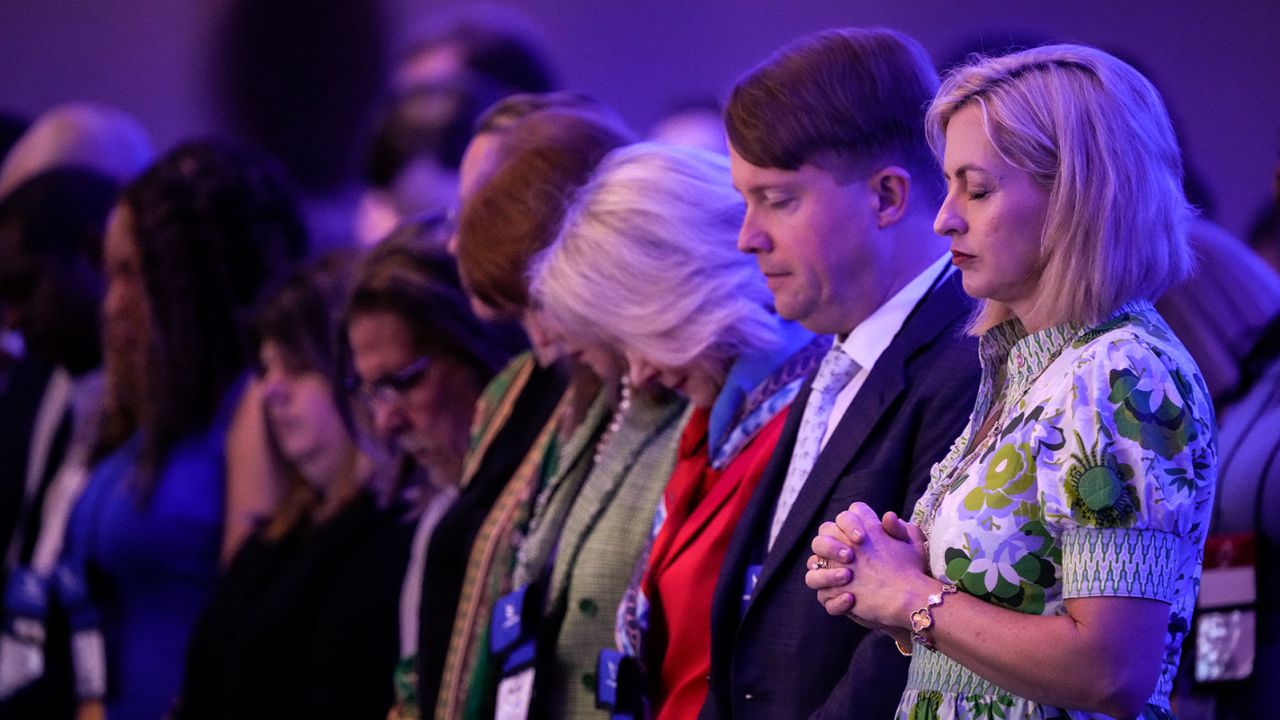 Attendees bow their heads in prayer at the start of the Faith & Freedom Coalition's policy conference in Washignton, DC, on June 23, 2023.