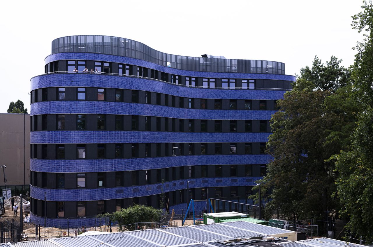 Blue tiles clad the curved building.