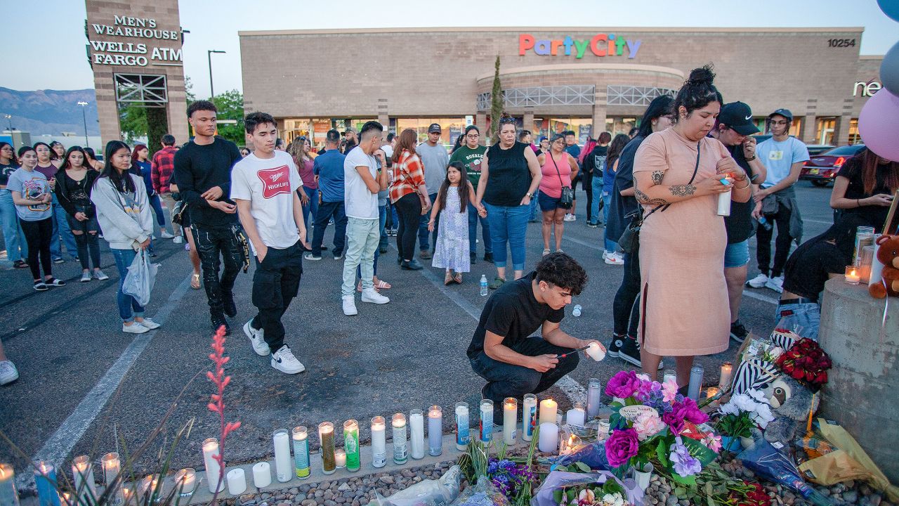 Mourners light candles during a vigil for Alexia Rael and her cousin Mario Salgado-Rosales on May 10, 2022, in Albuquerque, New Mexico.