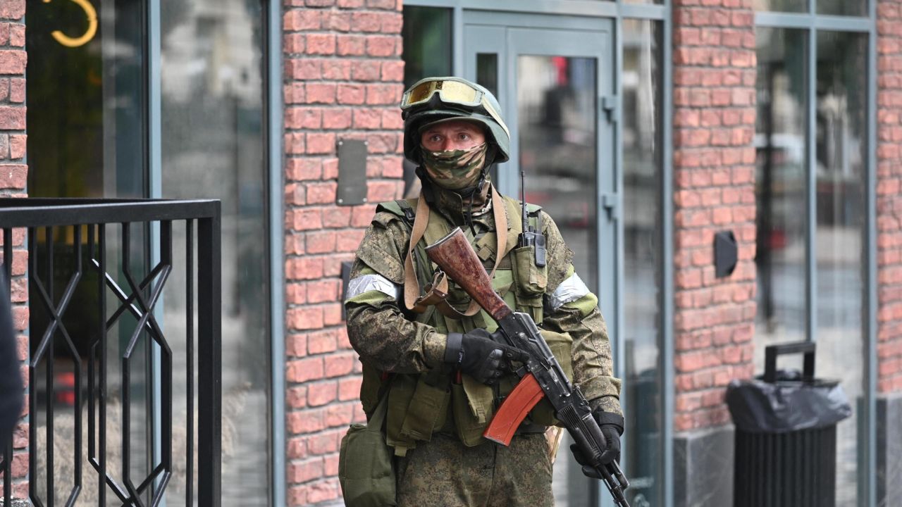 A fighter from the Wagner private mercenary group stands guard near the headquarters of the Southern Military District in the city of Rostov-on-Don, Russia, on June 24, 2023. 