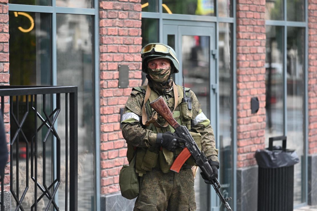 A fighter from the Wagner private mercenary group stands guard near the headquarters of the Southern Military District in the city of Rostov-on-Don, Russia, on June 24, 2023. 