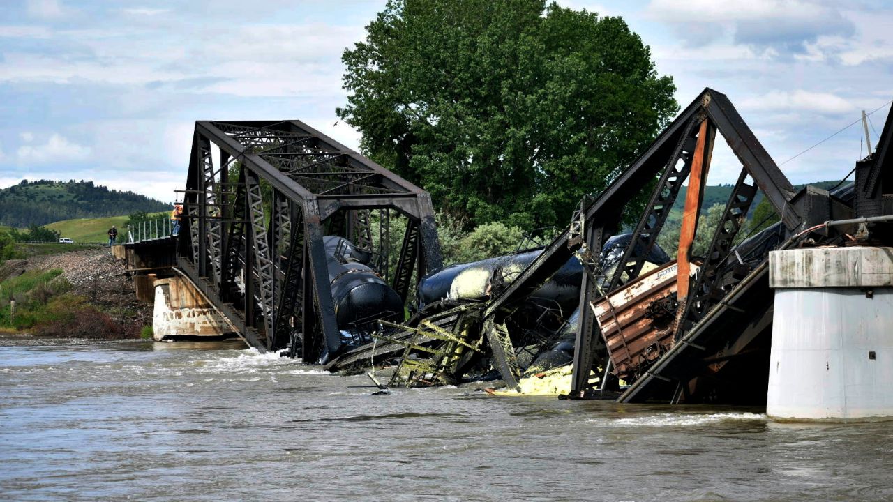 Several train cars are immersed in the Yellowstone River after a bridge collapse near Columbus, Montana, on June 24, 2023.  