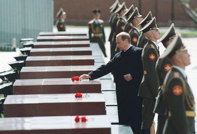 Putin sets a flower on a tomb during his inauguration ceremony in May 2000 at the Kremlin in Moscow. He was sworn in as Russia's second democratically elected president.