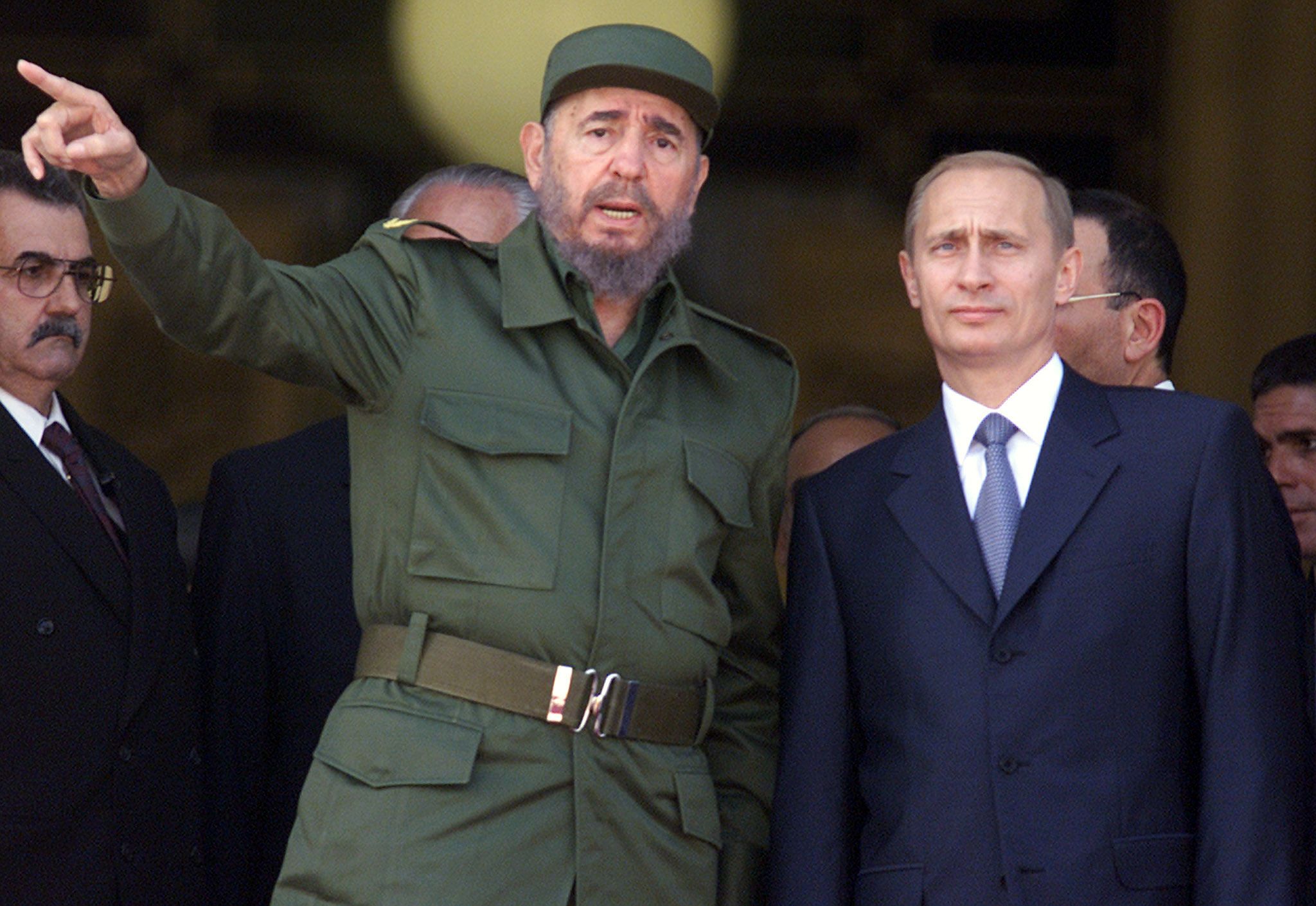 Cuban leader Fidel Castro chats with Putin at the top of the steps of Havana's Palace of the Revolution during Putin's official welcoming ceremony in December 2000. Putin was on a four-day official visit to Cuba, the first by a Russian leader since the collapse of the Soviet Union.