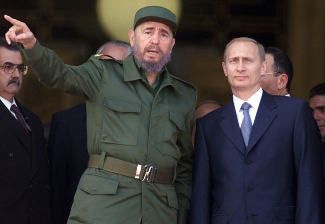 Cuban leader Fidel Castro chats with Putin at the top of the steps of Havana's Palace of the Revolution during Putin's official welcoming ceremony in December 2000. Putin was on a four-day official visit to Cuba, the first by a Russian leader since the collapse of the Soviet Union.