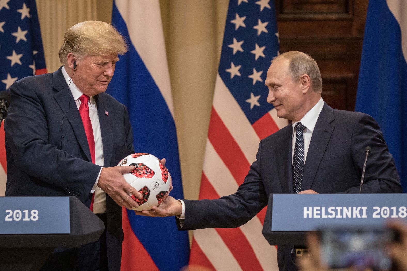 Putin hands US President Donald Trump a World Cup football during a joint press conference after their 2018 summit in Helsinki, Finland. The two leaders met one-on-one and discussed a range of issues, including the 2016 US election.