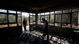Palestinian men check on a burned building, after an attack by Israeli settlers, near Ramallah, in the Israeli-occupied West Bank, June 21, 2023.
