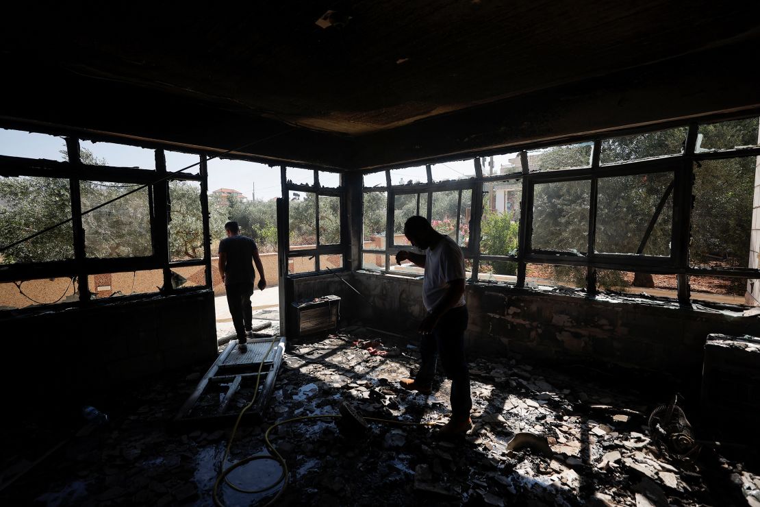 Palestinian men check on a burned building, after an attack by Israeli settlers, near Ramallah, in the Israeli-occupied West Bank, June 21, 2023.