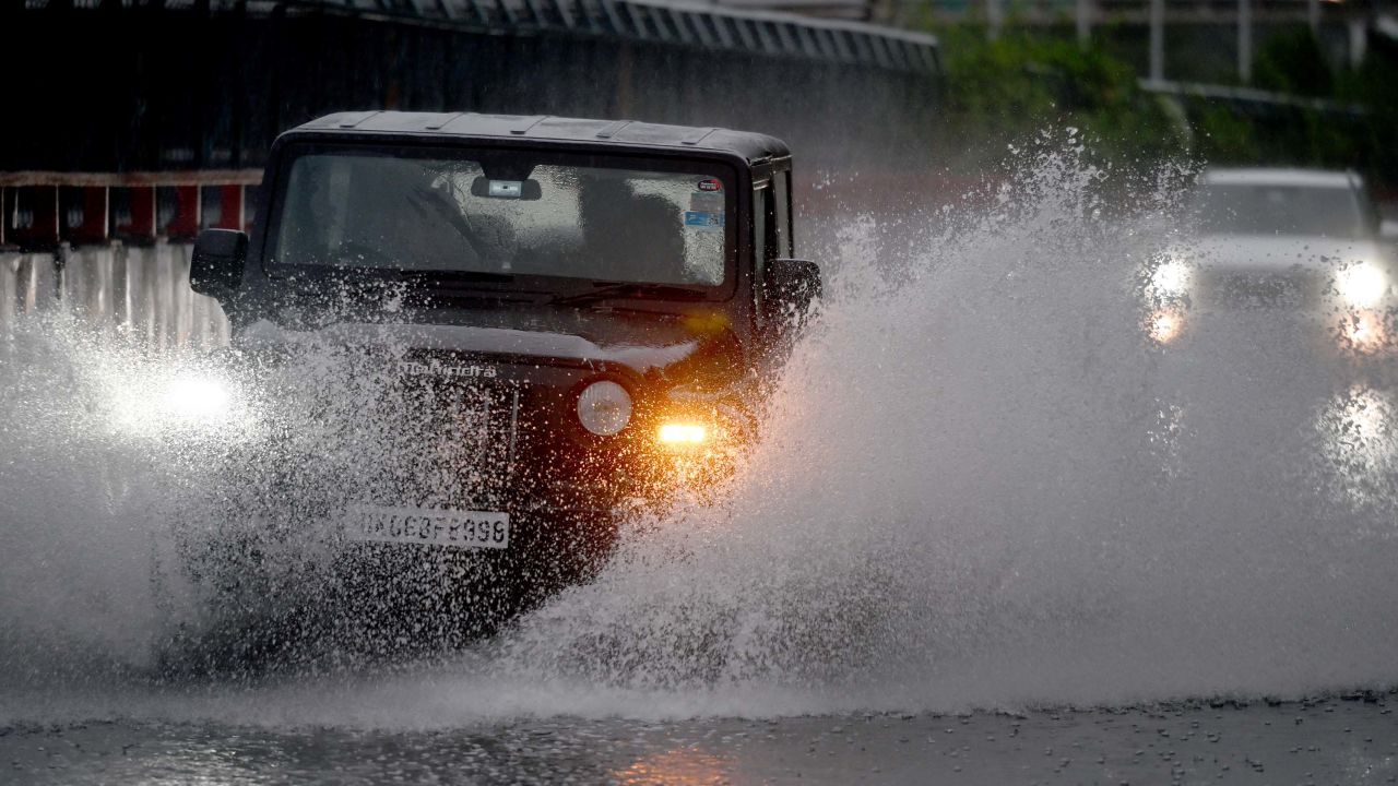 Commuters pass through a heavily waterlogged stretch of road on June 25, 2023.