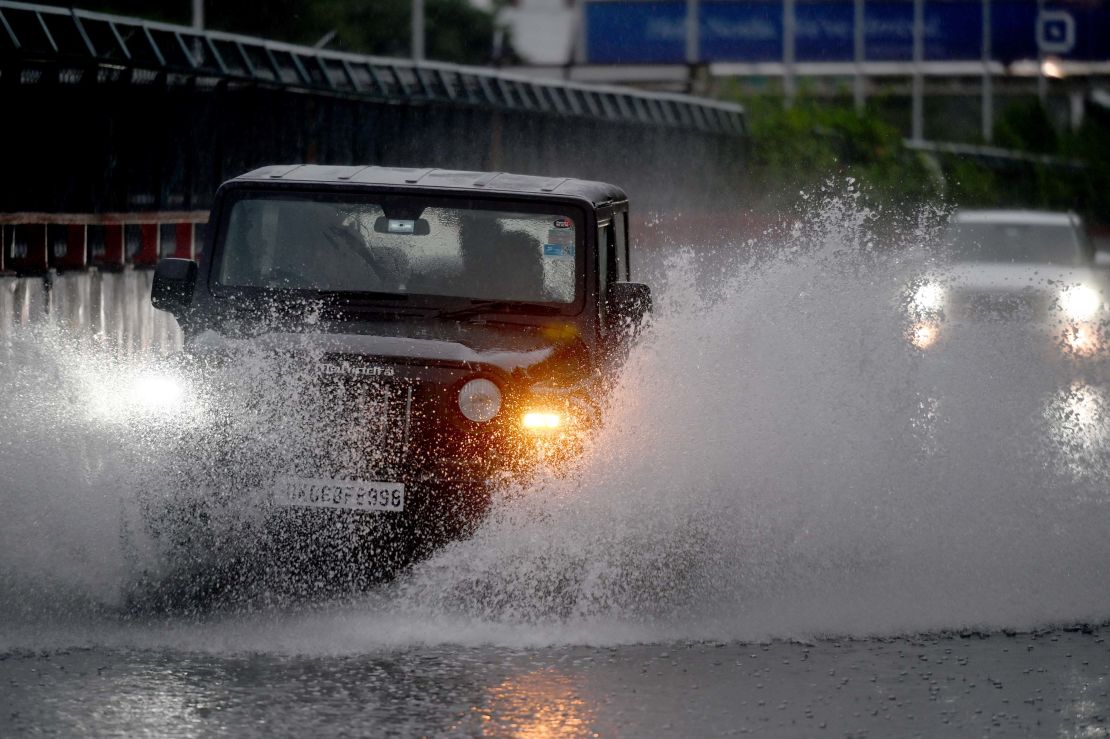 Commuters pass through a heavily waterlogged stretch of road on June 25, 2023.