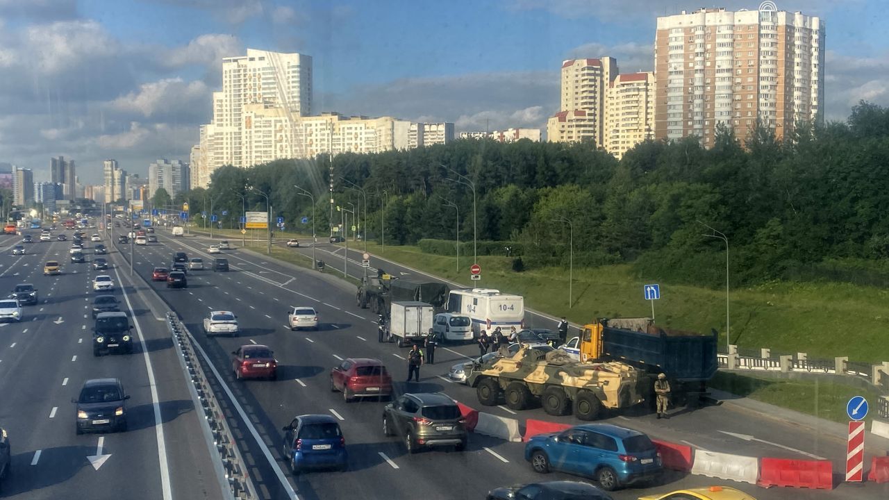 Russian police officers, traffic police officers and servicemen block part of a highway entering Moscow on June 24, 2023.