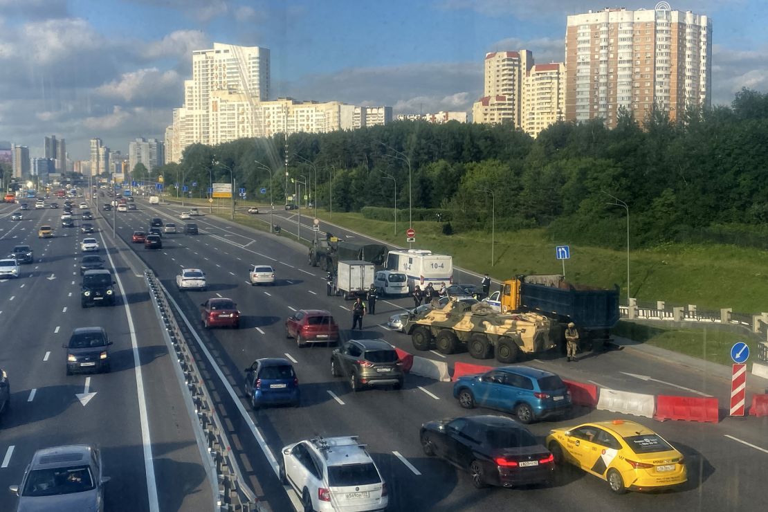 Russian police officers, traffic police officers and servicemen block part of a highway entering Moscow on June 24, 2023.