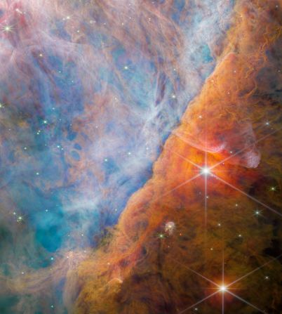 The James Webb Space Telescope captured the Orion Bar, a part of the Orion Nebula that is being eroded by stellar radiation emanating from the Trapezium Cluster.