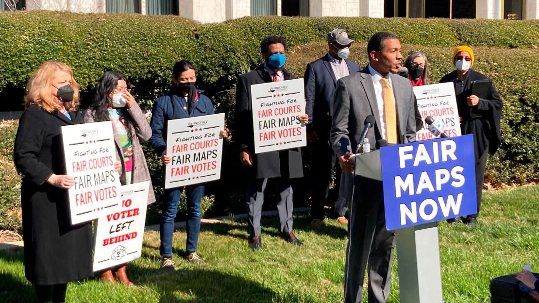 Reggie Weaver, at podium, speaks outside the Legislative Building in Raleigh, North Carolina, Feb. 15, 2022, about a partisan gerrymandering ruling by the North Carolina Supreme Court. 